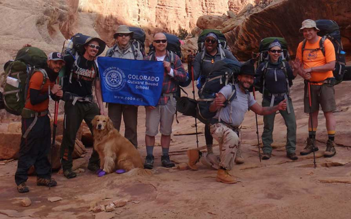 a group of veterans pose for a picture on an expedition with outward bound